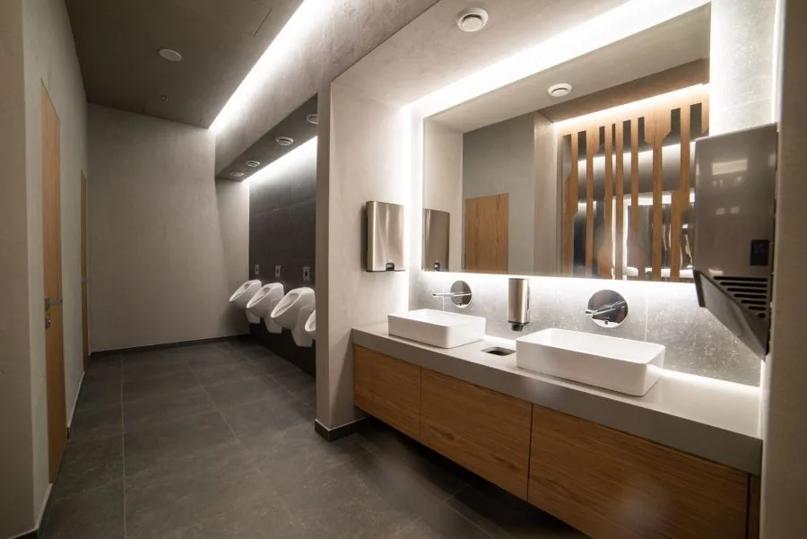 img-restroom Modern restroom with clean sinks and urinals maintained by professional government cleaning services.