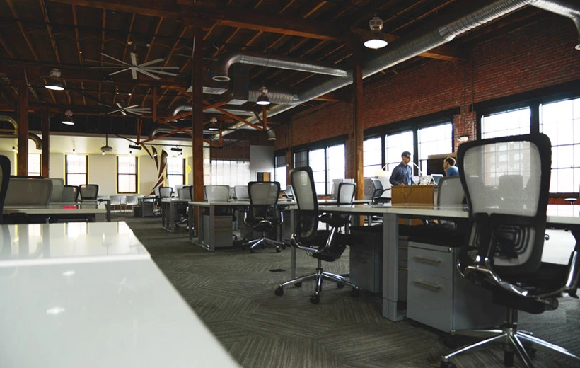 gallery-image-03 industrial-style open office features high-backed mesh chairs